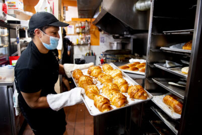 Small business owner Fernando Rosas works in his bakery La Casa Del Pandebono in East Boston. Rosas participated in the East Boston Consult-a-thon organized by business professor Julia Ivy between four small-business owners in East Boston and a volunteer group of millennial consultants. Photo by Ruby Wallau/Northeastern University